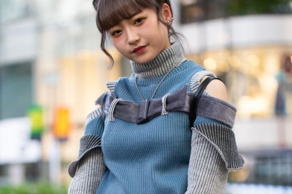 TOKYO, JAPAN - OCTOBER 28:  A local is seen on the street in Harajuku wearing black Unif backpack, blue/grey sweater with straps, grey pants, white shoes and pocket chain on October 28, 2018 in Tokyo, Japan.  (Photo by Matthew Sperzel/Getty Images)